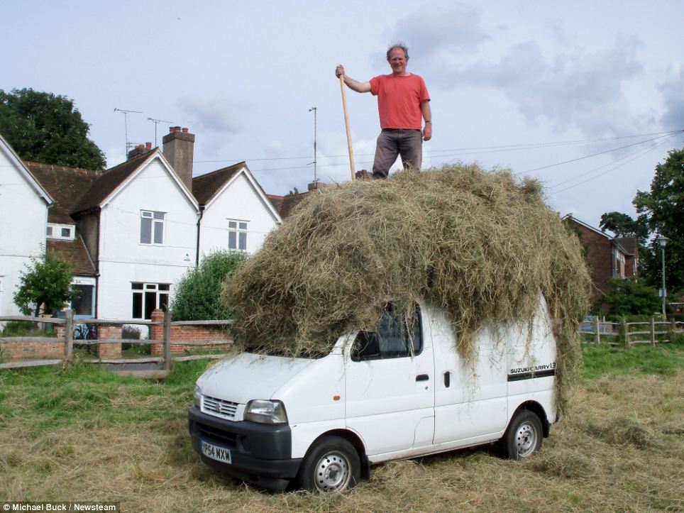 Hard at work: Mr Buck spent two years gathering materials and contructing the house at the bottom of his garden