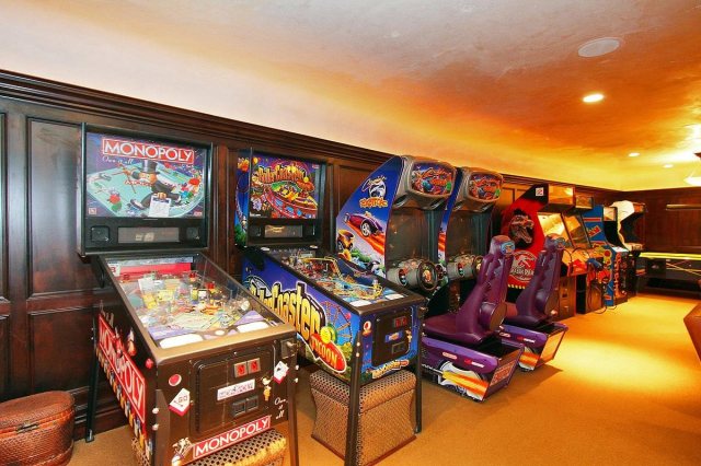 A wide selection of arcade games lines the wall. 