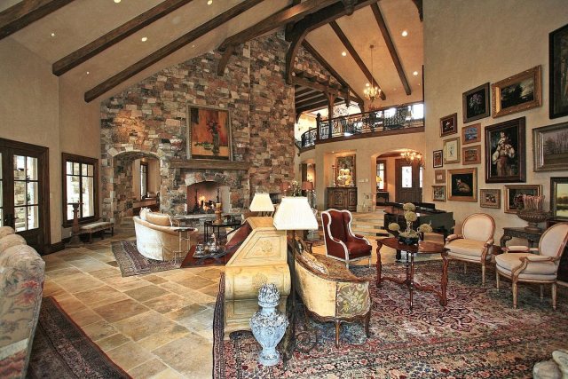 There's a ton of art lining the walls, and another limestone fireplace dominates the opposite side of the same room. 
