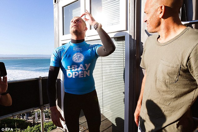 Fanning looks to the skies as he recalls the moment he was almost bitten by a shark (right with him is fellow champion Kelly Slater)